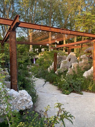 View of the Samaritans' Listening Garden, including the planting and a steel archway at the garden's entrance.