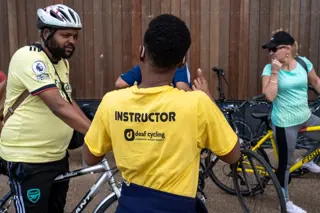 Stationary deaf cyclists group with instructor