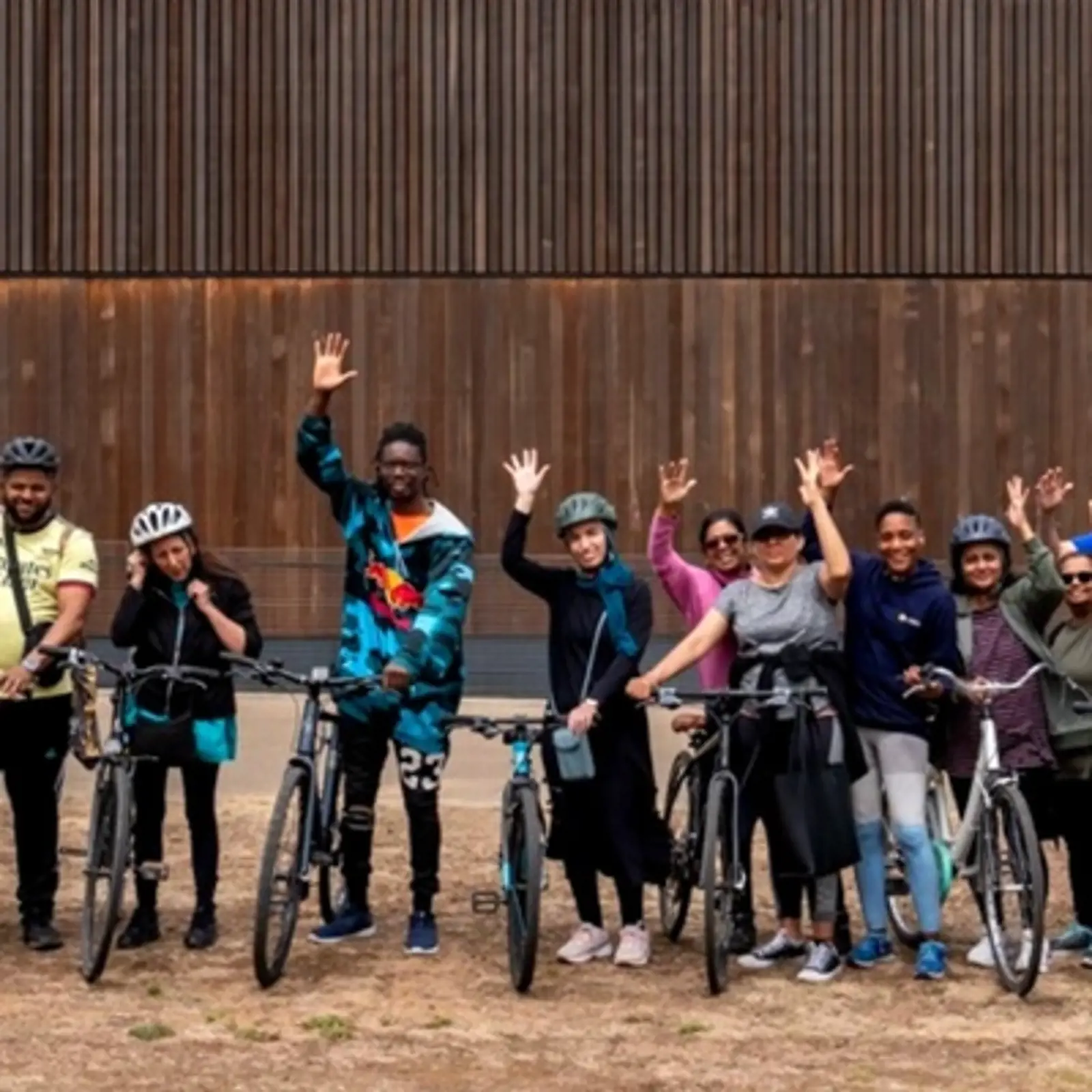 Deaf cyclists group waving