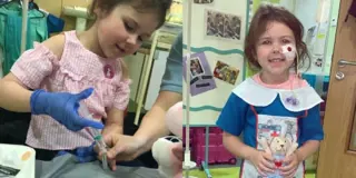 Millie in a nurses uniform and learning about syringes at Glasgow Children’s Hospital Charity