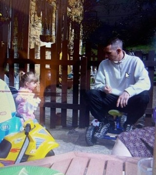 Paul pictured with his daughter in a garden