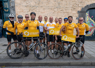 The Ride4Life team stood together at the finish line with their bikes