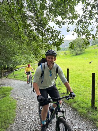 Ardonagh Specialty colleague cycling on a bike