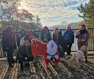 Eight from Atlanta Stoke on Trent give back day on 9 mile walk in fancy dress collecting donations