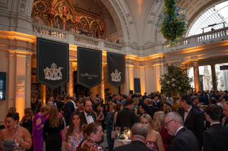 People holding drinks and talking in the drinks reception of the Spotlight Awards event