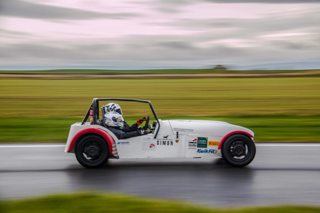 A person racing in a Speed of Sight car at Silverstone.