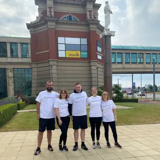 Paymentshield team outside Manchester's Trafford centre, before abseiling