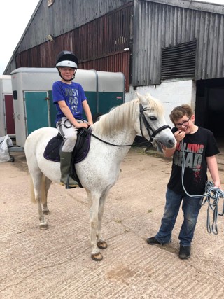 Two boys with a pony