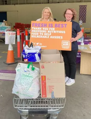 Resilium's give back day, two volunteers and their food donations for Food Bank in Australia