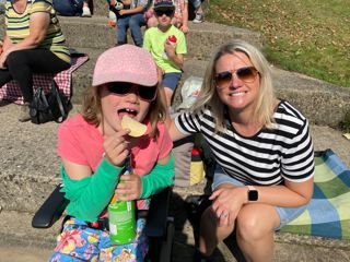 Lucia eating crisps with her mum.