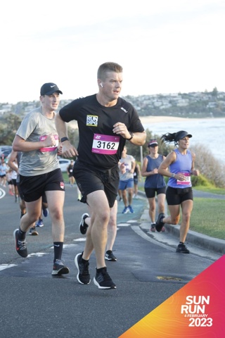 Luke Eagle in a black thsirt, running for RUNDIPG fundraiser